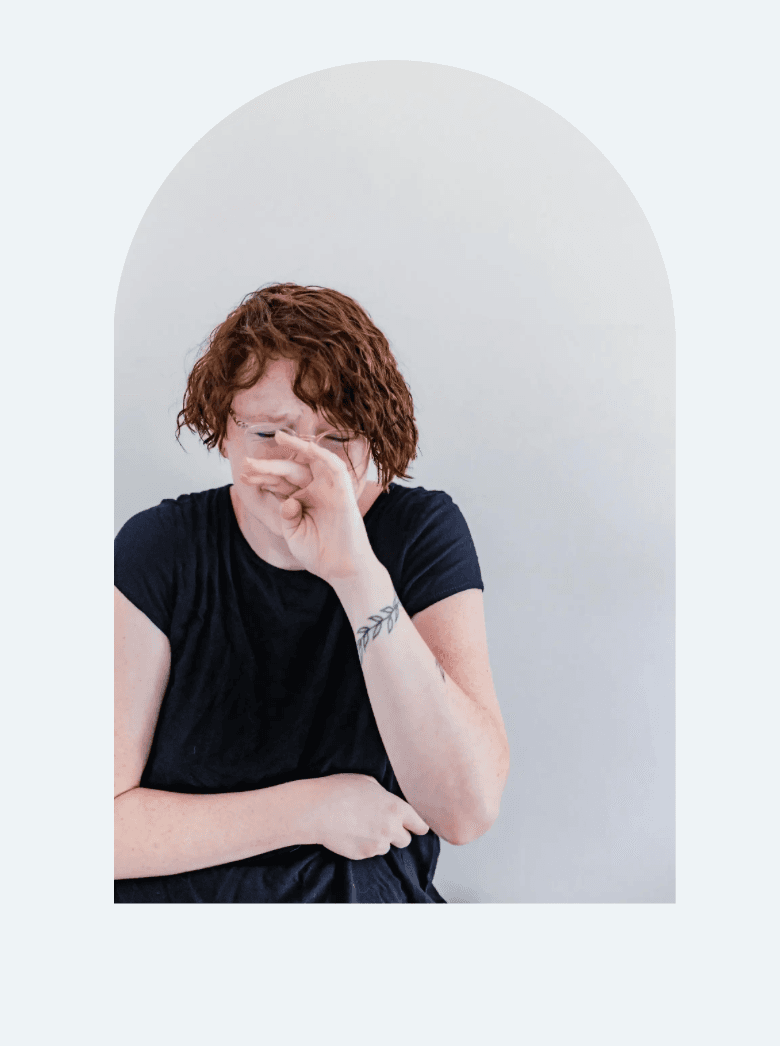 A person covering their face with a hand