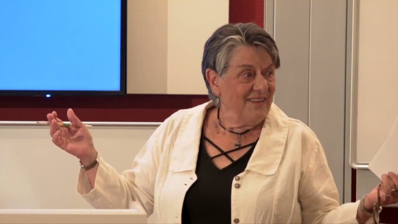 Dr. Janja Lalich speaking at a lectern during a university workshop