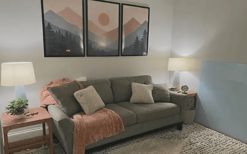 My Mt. Juliet therapy office — a soft green couch, warm lamps, and mountain artwork